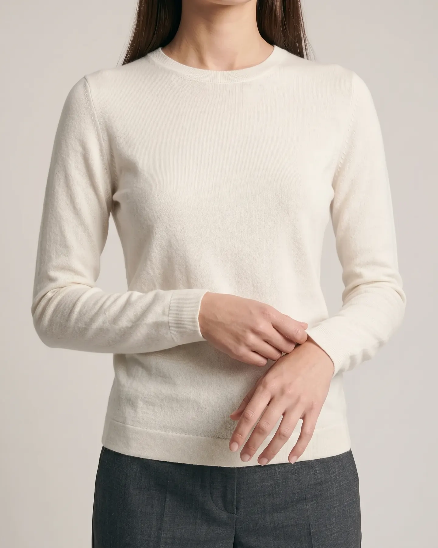 A close view of the knit, the rib and the weave of the cream jumper